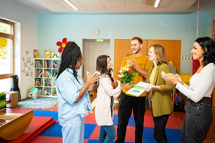 Certification of an early childcare center: pedagogues receive flowers and their certificate